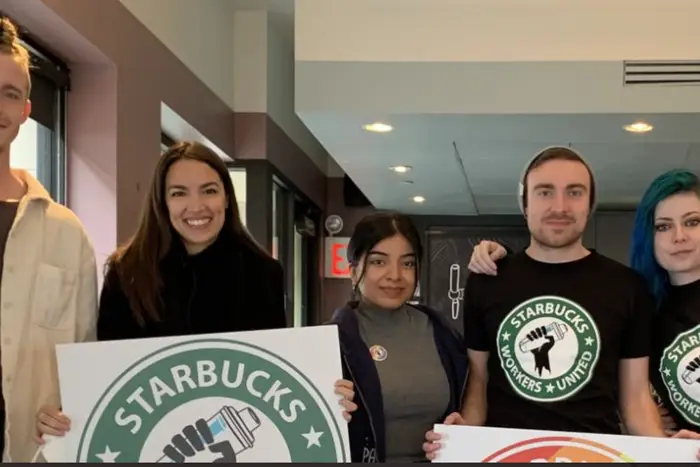 A photo of Starbucks workers with Rep. Alexandria Ocasio-Cortez